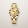 Gold fluted bezel day and date watch with champagne dial